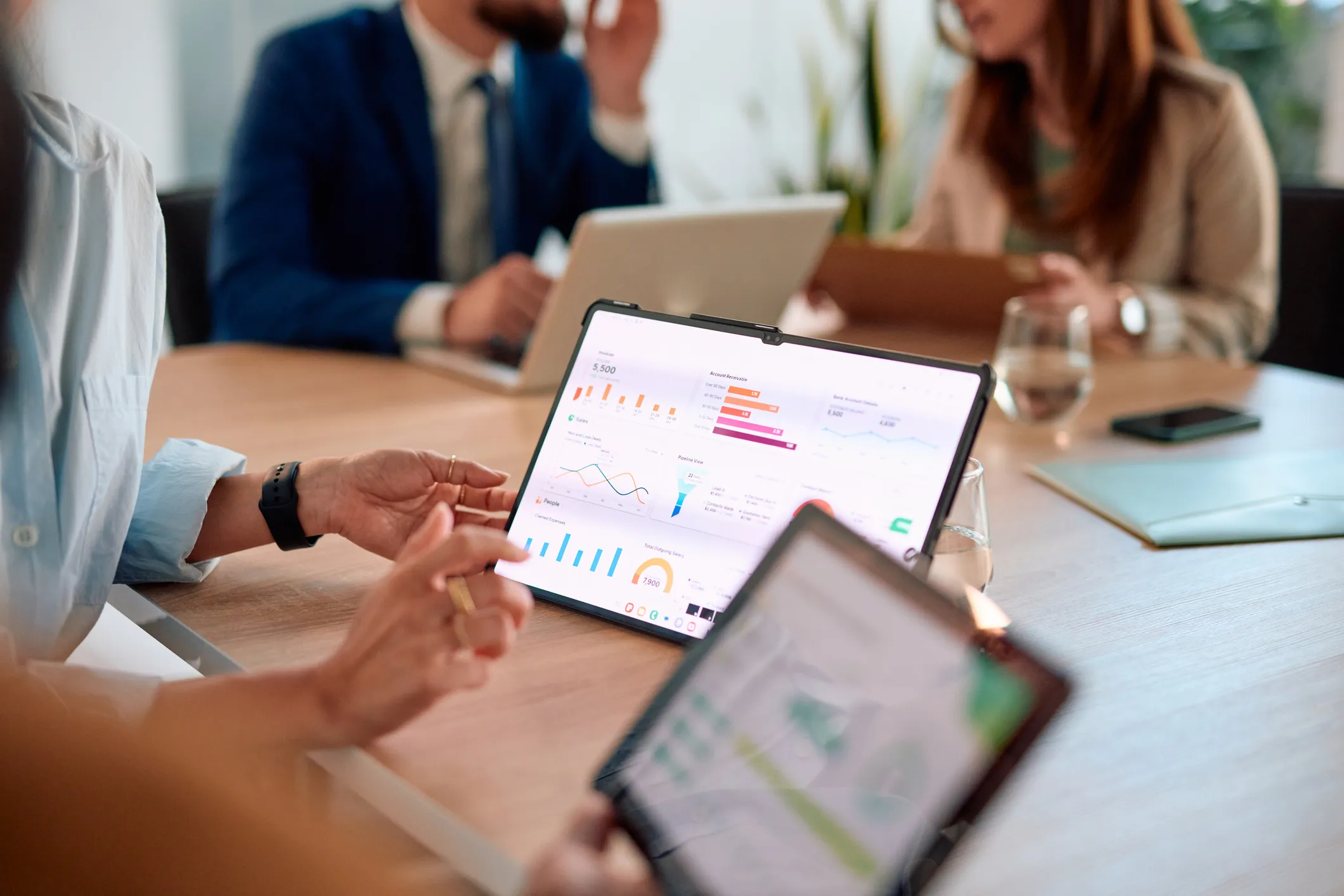 People looking at analytics on a tablet