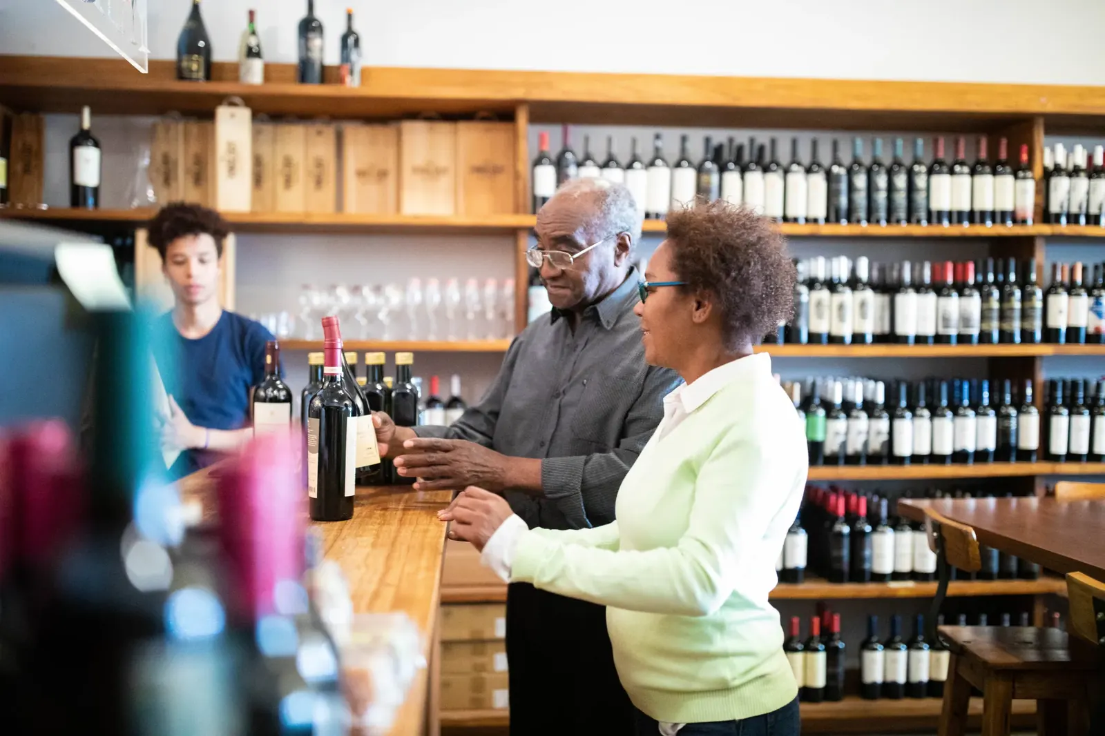 Tasting room staff helping customers choose wine